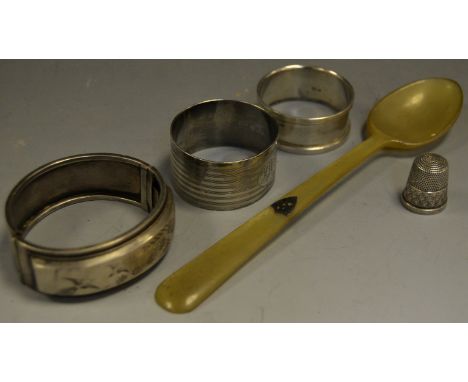 A 19th Century Scottish horn spoon, silver shield shaped cartouche; a silver napkin ring, hallmarked Chester; another similar