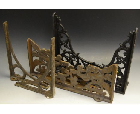 A  pair of Victorian cast iron shelf brackets; a 20th century cold cast pair of  shelf bracket depicting cherubs; another pai