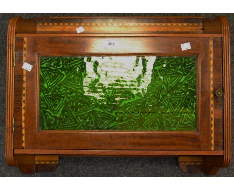 An early 20th century mahogany spice cupboard, barberpole stringing throughout, green glass door enclosing single drawer and 