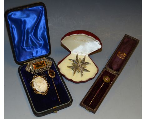 A gold coloured stick pin, another, ruby inset; a gold coloured cameo brooch; a filigree brooch, boxed (5)