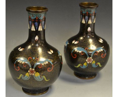 A pair of Chinese cloisonné enamel ovoid vases, decorated in polychrome and inlaid with scrolling wire, 16.5cm high