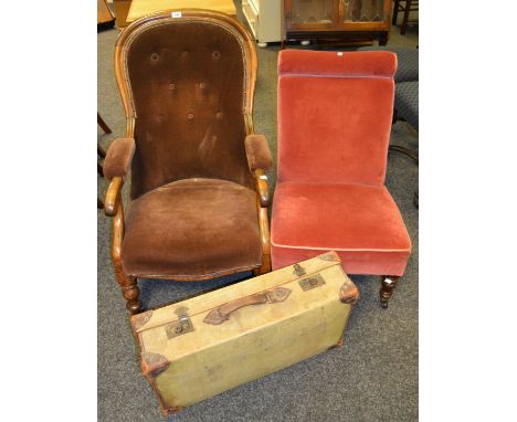 An early 20th century mahogany button back nursing chair; another similar; an early 20th century leather mounted canvas suitc