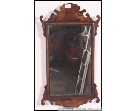 A 19th century walnut pier mirror. The central mirror in walnut banded surround with scalloped top and bottom