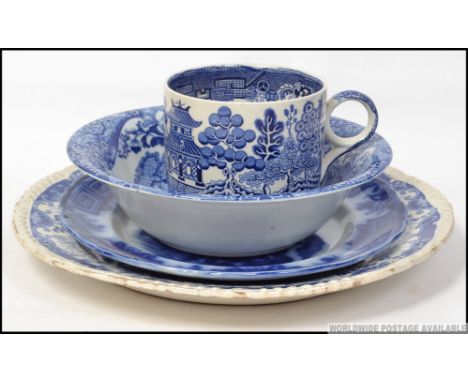 A group of 4 traditional blue and white English porcelain pieces to include Doulton Willow Ware oversized cup , Spode bowl et