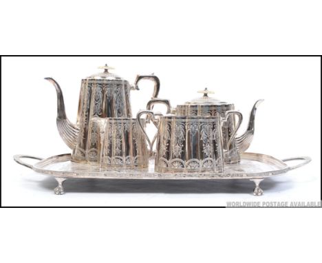 An early 20th century silver plated tea service being chase decorated  to include teapot and coffee pot, sugar bowl and cream