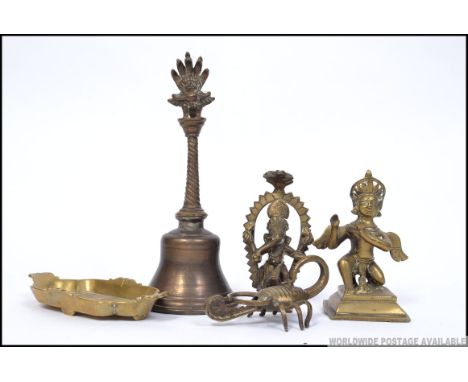 A collection of Indian 19th and 20th century brass wares to include deity Ganesh and others along with a brass tray with port