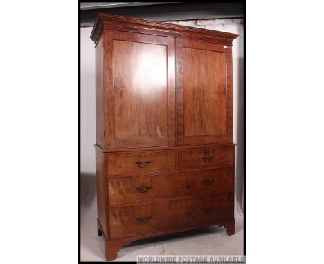 A late 19th century Victorian mahogany linen press tallboy. The base having short over deep drawers being raised on bracket f