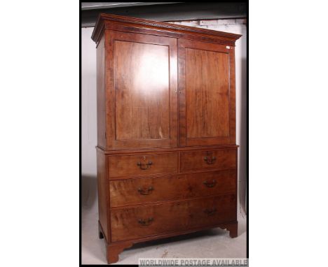 A late 19th century Victorian mahogany linen press tallboy. The base having short over deep drawers being raised on bracket f