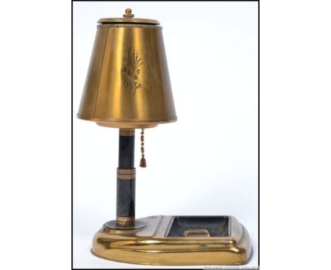 A 20th century retro brass cigarette dispenser having pull down action made in the form of a table lamp. H23cm 