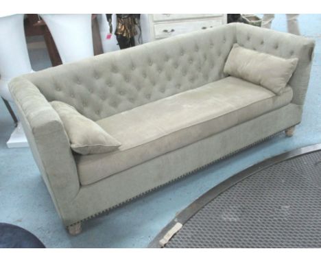 SOFA, from India Jane, buttoned back in moss green upholstery on turned oak feet with brass studded trim, 205cm x 90cm x 85cm