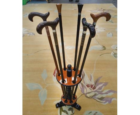 STICK STAND, in black lacquer with six walking sticks, 96cm H. (2)