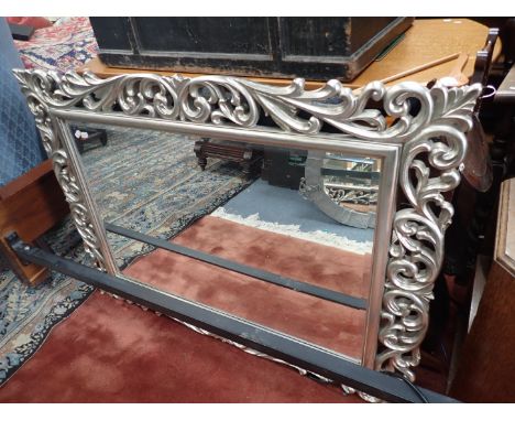 A ROCOCO STYLE WALL MIRROR with silvered frame 86 x 116cm