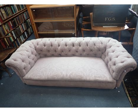 A LATE VICTORIAN CHESTERFIELD SOFA on squat turned front legs, upholstered in figured pink cloth