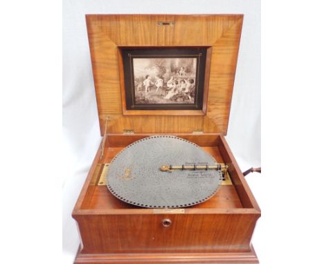 A LATE 19TH CENTURY WALNUT-CASED TABLE POLYPHON with marquetry lid,with a collection of 19 x 15 1/2 inch discs, on a purpose-