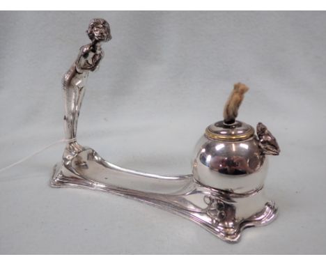 AN ART NOUVEAU UNMARKED WHITE METAL TABLE LIGHTER decorated with a female figure and enclosed frog taper, 16cm long