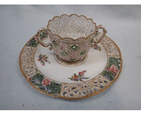 A 'MEISSEN' PIERCED CABINET CUP AND SAUCER painted with flowers and gilt, crossed swords mark