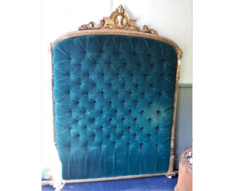 A 19TH CENTURY GILTWOOD OVERMANTEL MIRROR FRAME converted to a bedhead with buttoned upholstery 185cm high, 160cm wide (right