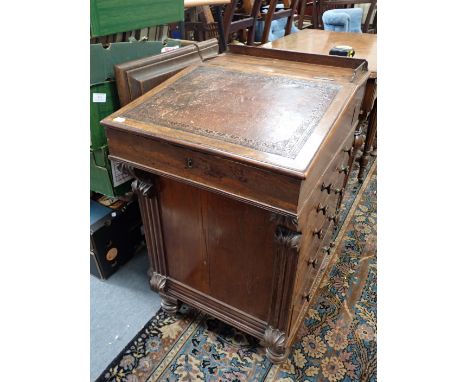 A REGENCY ROSEWOOD DAVENPORT with sliding top section, inkwell drawer released by interior knob, fitted with drawers and slid