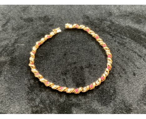 9ct gold diamond and ruby bracelet - 18cm long. 5 gm total weight 