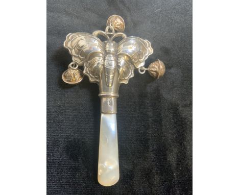 A silver hallmarked babyâ€™s rattle with mother of pearl handle. 