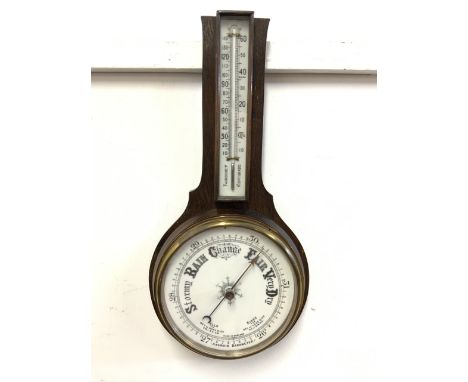 An early 20th century oak short aneroid barometer and thermometer. H:50cm