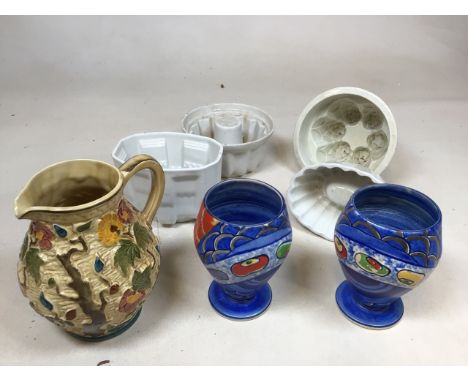 A pair of Wilkinson Art Deco vases together with an Indian tree moulded jug by H Wood and four jelly moulds 