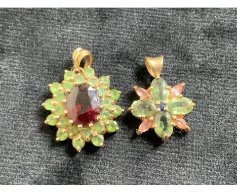 14ct gold pendant set with a central ruby 11mm with another in 9ct gold with pink and green stones 