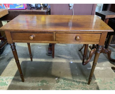 A small mahogany two drawer desk with turned handles and tapered legs. W:91cm x D:45cm x H:70cm