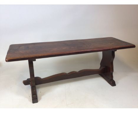 Small bench in Arts and Crafts taste. Shaped ends with pegged joints. Sash carved stretcher rail, standing upon trestle feet.