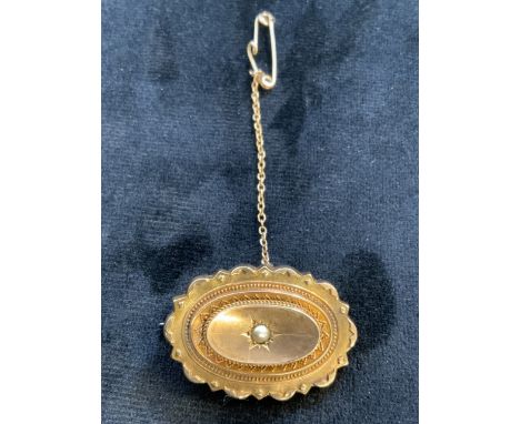 9ct gold oval brooch set with a single pearl with safety chain. Total weight 5gmW:3.5cm x H:2.5cm