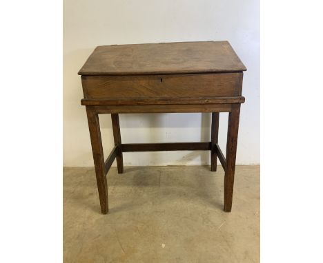 A late 19th early 20th century elm teachers school desk. W:91cm x D:58cm x H:108cm