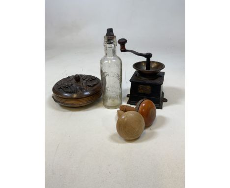 A vintage lot to include a metal coffee grinder, wooden carved lidded bowl, Bridgwater glass bottle and darning mushrooms. 