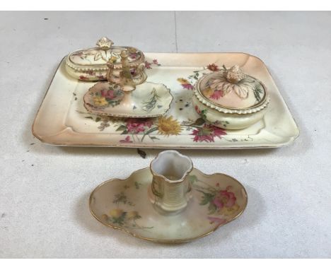 A Royal Worcester blush ivory dressing set with tray, ring stand, candle holder and two lidded trinkets pots. Also with a Roy