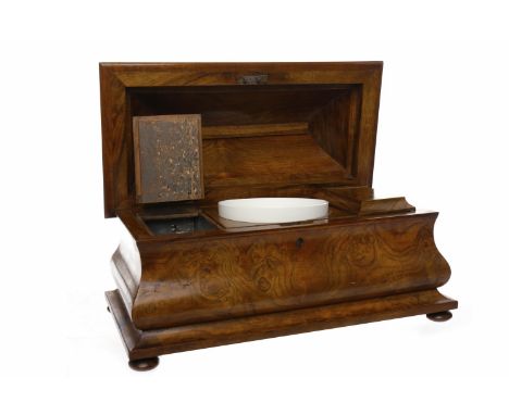 VICTORIAN SARCOPHAGUS SHAPED WALNUT TEA CADDY the domed hinged lid enclosing a ceramic mixing bowl flanked by two hinged lidd