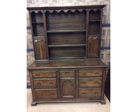 OAK DRESSER OF 18TH CENTURY DESIGNthe raised back with open shelves and two cupboards, the base with central cupboard and ser