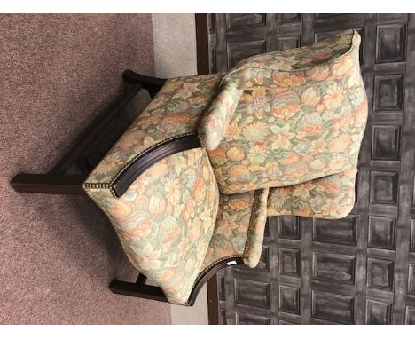 MAHOGANY FRAMED WING BACK ARMCHAIR OF GEORGE III DESIGNupholstered in machined tapestry, on square legs, joined by an H-stret