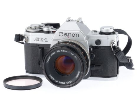 A Canon AE-1 35mm SLR Camera, silver, serial number 1158634, body G, shutter works, internal display works, appears to meter,