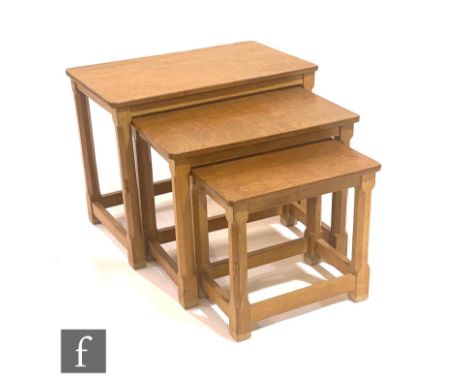 Robert 'Mouseman' Thompson - A nest of three rectangular occasional tables, with typical adzed tops above stretcher frames, e