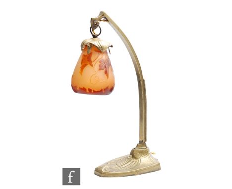 Galle - An early 20th Century Art Nouveau desk lamp, the suspended cameo glass shade cased in cinnamon over amber and cut wit