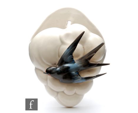 Clarice Cliff - Swallow - A wall pocket circa 1936, relief moulded with a swallow in flight in enamel colours over a cloud po