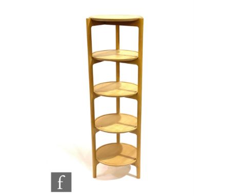 Ercol Furniture - A light oak five-tier circular shelving unit on triangular shaped frame, height 144cm and diameter 48cm. 