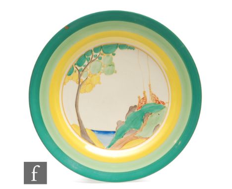 Clarice Cliff - Secrets - A 9 inch circular plate circa 1933, hand painted with a stylised tree and cottage landscape within 