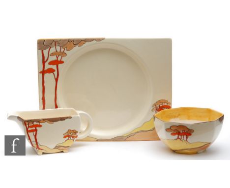 Clarice Cliff - Coral Firs - A large Biarritz plate decorated to the shoulder with a stylised tree lined coastal landscape, t