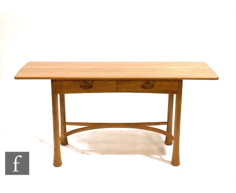 Ercol Furniture - A light elm Kelmscott side table, the top of rounded rectangular form with a bevelled front edge, fitted wi