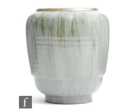 Poole Pottery - A post war vase of tapering form with a ribbed foot, the whole decorated in a streaked green glaze, impressed
