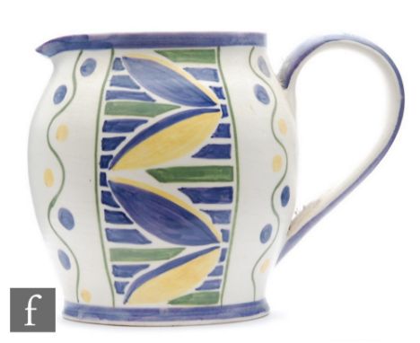 E Radford - A ceramic jug of ovoid form with loop handle, decorated with stylised leaves in blue and yellow between vertical 