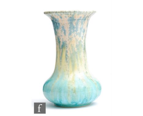 Ruskin Pottery - A crystalline glaze vase of globe and shaft form decorated in a pale yellow to blue glaze with dark crystall