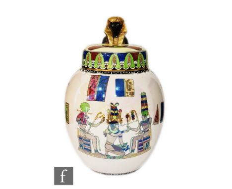 Carlton Ware - A 1920s ginger jar and cover decorated in the Tutankhamun pattern with enamelled Egyptian motif against a pear