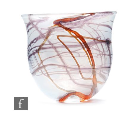 Isle of Wight - A later 20th Century glass vase of flared form, decorated with whiplash lines over a pale opal iridescent gro