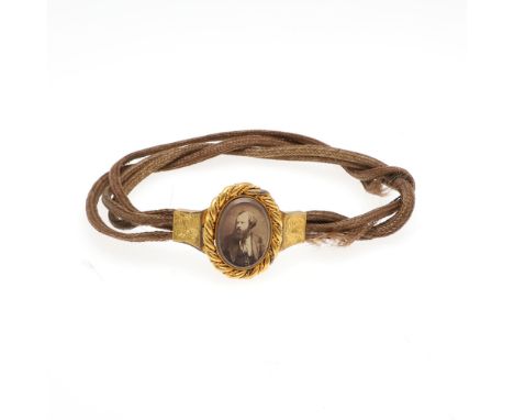 Smith, Albert. Photographic portrait miniature set in gilt metal frame, on woven hair bracelet or necklace. Provenance: By de